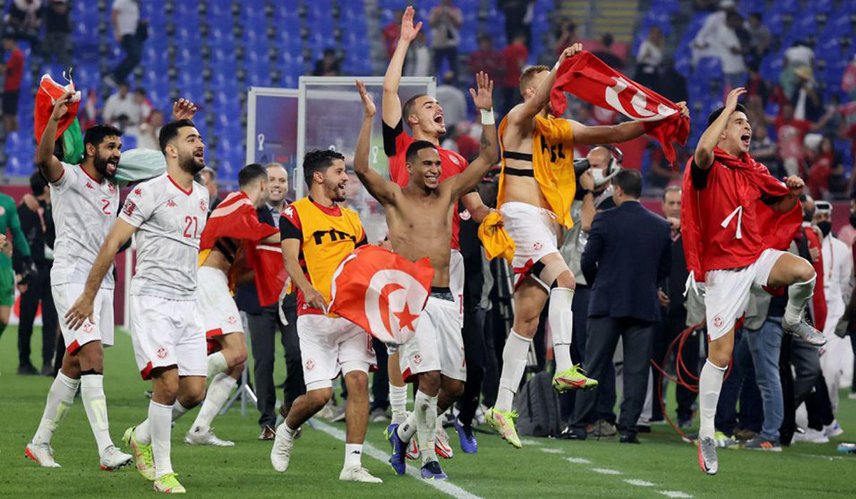 Tunisia players celebrate with fans after the match
